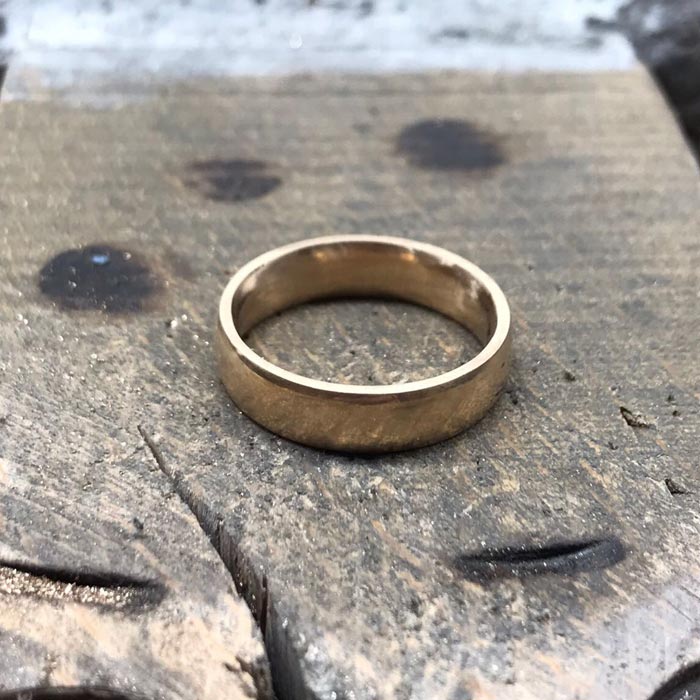 Polished-wedding-band-on-workbench.jpg